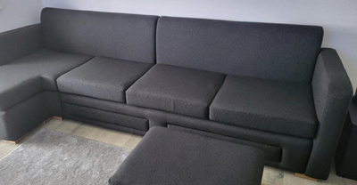 Upholstered sofa and foot cushion